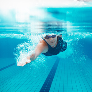 person swimming in lap pool